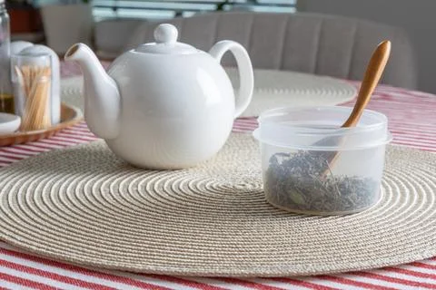 This high-angle shot captures a cozy tea preparation scene on a dining table. Stockfoto's