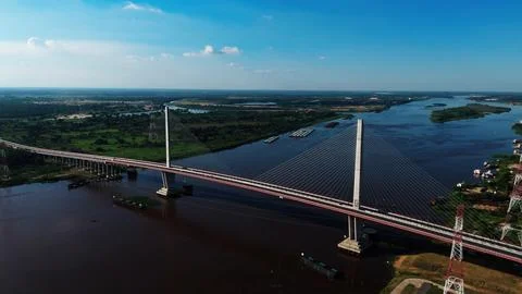 High-angle shot captures a modern bridge spanning a broad river 스톡 사진