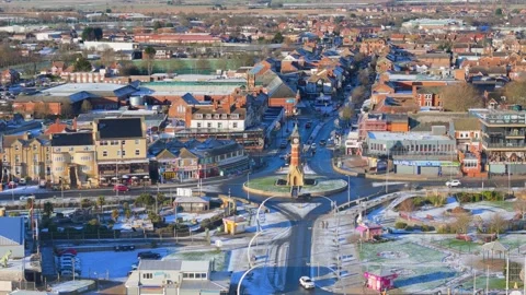High-angle shot captures a town's roundabout and central clock tower. Snow Stock Footage 343694962