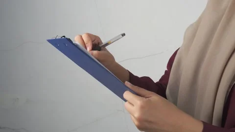 High angle shot of checking or taking notes on a clipboard while standing Stock Footage 277242953