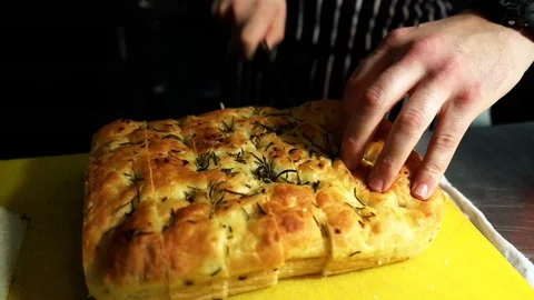 High angle shot of chef cutting garlic bread Stock Footage 106810555