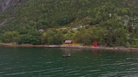 High angle shot of classic boat with people on water in Norway fjord Vídeos de archivo 320245552