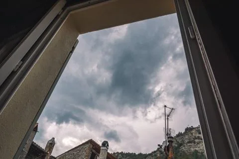 A high angle shot of a cloudy sky on a rainy morning through an open window i Stock Photos