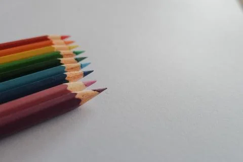 High angle shot of colorful sharp pencils on a white surface Foto stock