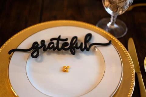 High-angle shot of corn kernel with a "grateful" black chocolate text  on an emp Stock Photos