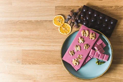 High angle shot of decorative ruby chocolate with walnuts and dark chocolate Stock Photos