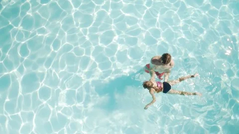 High-angle shot of a father teaching daughter to swim Stock-Footage 76539429