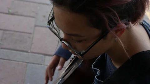 High angle shot of girl playing guitar Stock Footage 122722683