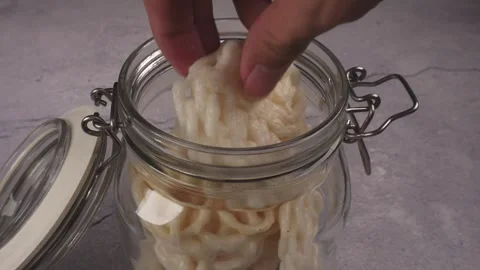 High angle shot of hand takes cracker from glass jar Stock Footage 277682467