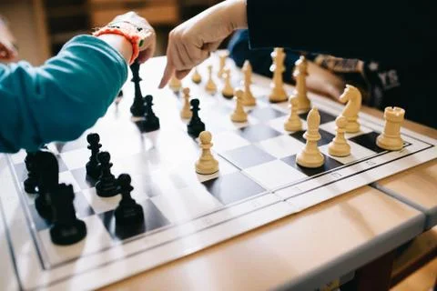 High angle shot of human hands playing chess and replacing the figures Stock Photos