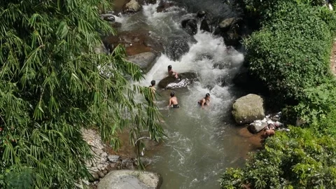 High angle shot of local people bathing in natural river. Stock Footage 336322184