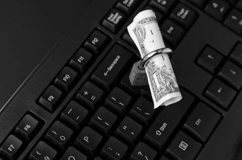 High angle shot of a lock around a dollar bill on a black laptop 写真素材