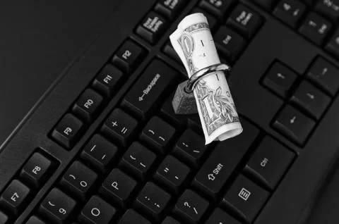 High angle shot of a lock around a dollar bill on a black laptop 写真素材