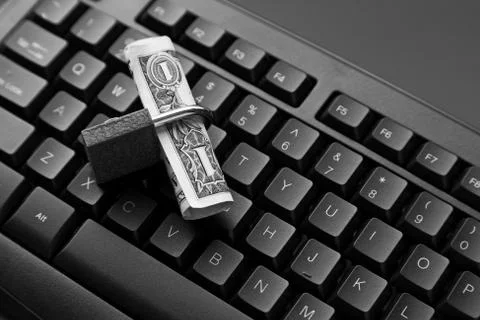 High angle shot of a lock around a dollar bill on a black laptop 写真素材