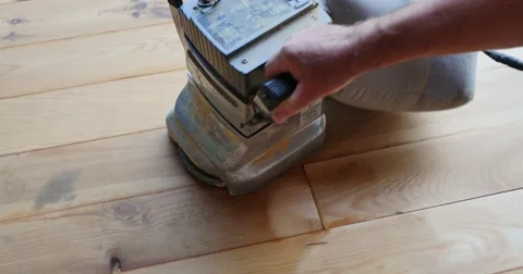 A high angle shot of a man sanding a parquet with a sanding machine Stock Footage 55327881