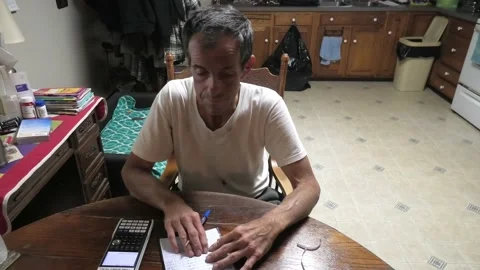 A High Angle Shot of a Middle Aged Man Paying Bills Stock-Footage 156702062