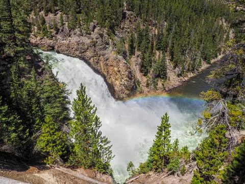 High angle shot of mighty Upper falls of Yellowstone with rainbow upon it on a Stock Photos