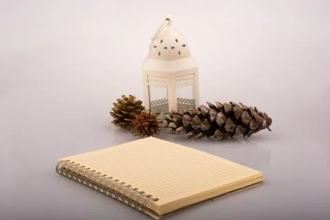 High angle shot of a notebook with acorns on the side on a white background Stock Photos