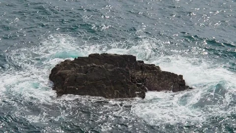 High-angle shot of ocean waves and white foam breaking over a dark, isolated Stock-Footage 345047251