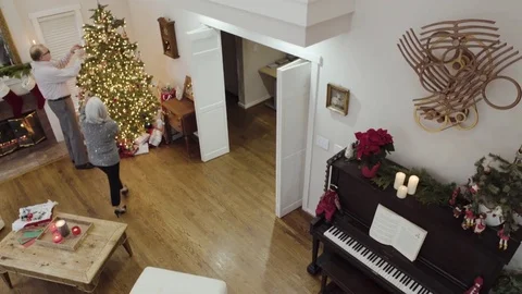 High-angle shot of an old couple decorating a Christmas tree 動画素材 73116018