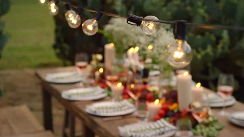 High angle shot of an outdoor dining table and overhead lights, setup and Video stock 140554308