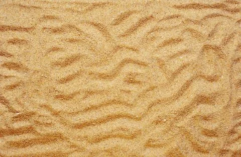 High angle shot of patterns and textures on the sand-covered surface Fotos de archivo