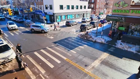 High angle shot of pedestrians and traffic at snowy New York intersection Stock Footage 328635207