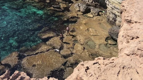 High Angle Shot of People walking out of Sea Caves Stock Footage 91063887