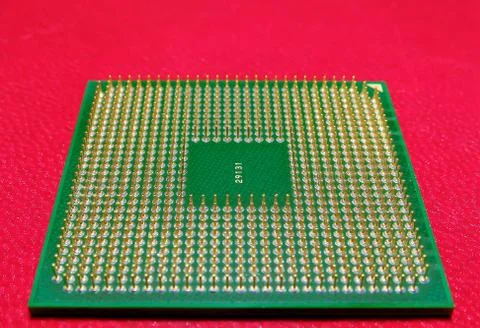 High angle shot of the pins of a microprocessor on a red background 写真素材
