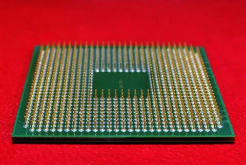 High angle shot of the pins of a microprocessor on a red background Stock Photos
