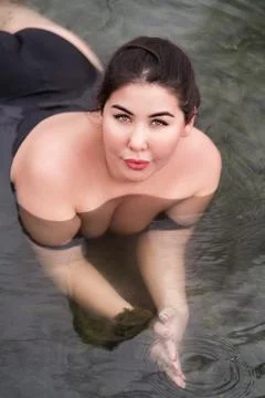 High angle shot of plus size young woman with big breast in bathing pool Stock-Fotos