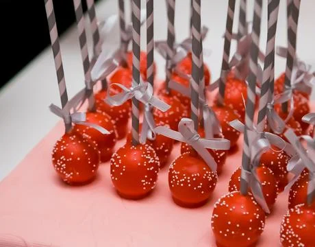 High angle shot of red cake pops with decorated gray handles Photos