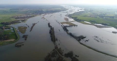 High angle shot of a river barge navigating a broad flooded river in winter Stock Footage 87137804