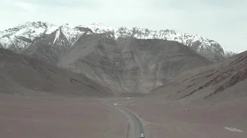 High-angle shot of a road between rocky mountains and snow Stock Footage 280376464
