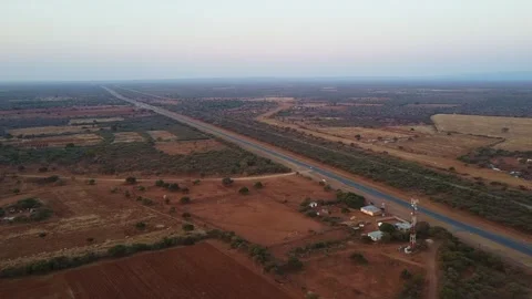 High angle shot of a road cutting through a dry african landscape at sunset Stock Footage 317729721