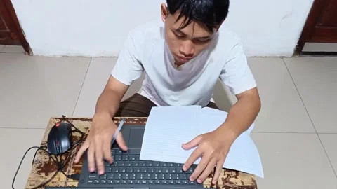 High-angle shot of a serious Asian student or worker. 스톡 동영상 321937170