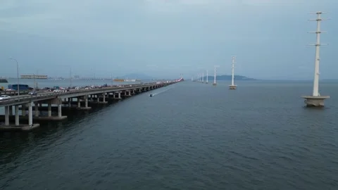 High angle shot showing the full span of Penang Bridge over calm waters. Video stock 318269485