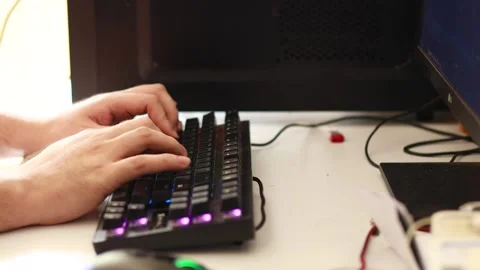 High angle shot from the side of a man’s hands interacting with an rgb Stock Footage 236622590