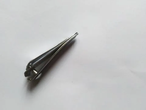 High-angle shot of a silver nail clipper on a white surface Stock Photos
