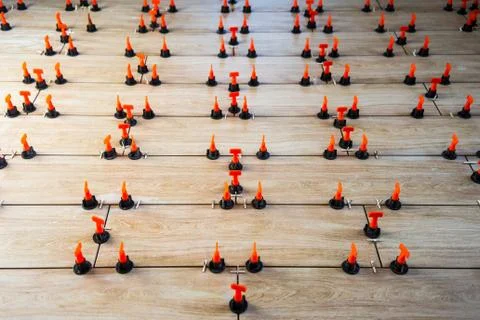A high angle shot of small orange and black objects arranged in a pattern on  写真素材