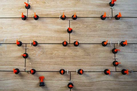 A high angle shot of small orange and black objects arranged in a pattern on  Foto stock