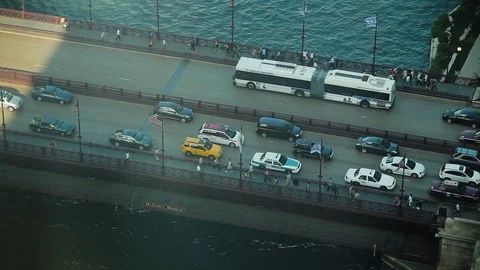 High angle shot of traffic and pedestrians on a bridge over a river Stock Footage 97101346