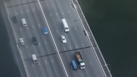 High angle shot of traffic on a bridge over a river Stock Footage 97103172
