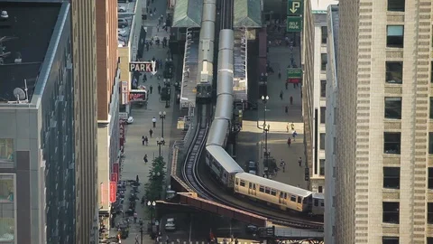 High angle shot of a train approaching a railway station in Chicago Stock Footage 97101569