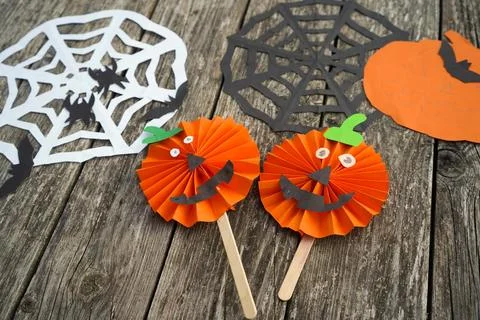 High angle shot of two completed handmade paper pumpkin jack-o'-lanterns on.. Stock Photos