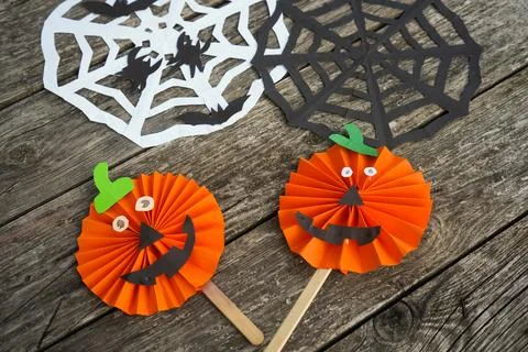 High angle shot of two finished handmade paper pumpkin jack-o'-lanterns on .. Stock Photos