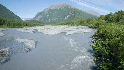 High angle shot of two paddleboarders flowing down river Stock Footage 113256662