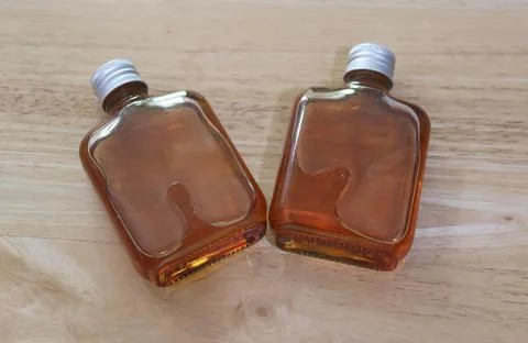 High angle shot of two plastic flask bottles filled with natural honey  Stock Photos