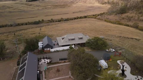 High-angle shot of villa grounds with solar panels and a stone labyrinth. Vídeo Stock 332542312