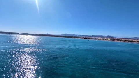 High angle shot while parasailing with a speed boat along the blue sea Vídeo Stock 265583044